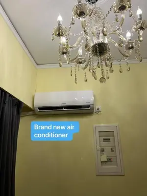 a chandelier in a room with a sign that reads brand new air controller at Qqueen House in Piraeus