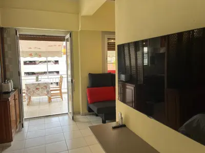 a kitchen and living room with a couch and a table at Qqueen House in Piraeus