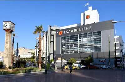 a large building with a sign on the side of it at Qqueen House in Piraeus
