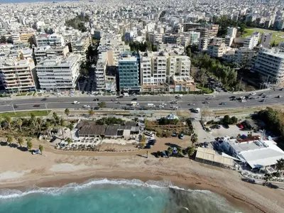 an aerial view of a beach and buildings at Athenian Coastal Urban Living in Athens