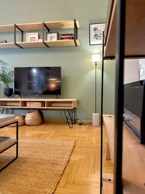 a living room with a flat screen tv on a wall at Athenian Coastal Urban Living in Athens