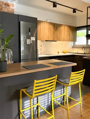 a kitchen with two yellow chairs at a counter at Athenian Coastal Urban Living in Athens