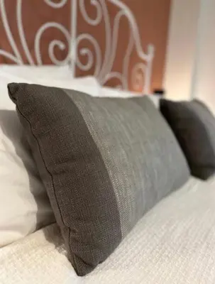 a bed with two pillows on top of it at Athenian Coastal Urban Living in Athens