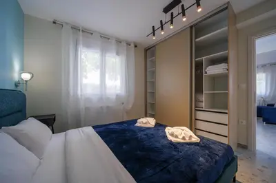 a bedroom with a bed with two towels on it at Peaceful Private Bungalow VIPGreece in Athens