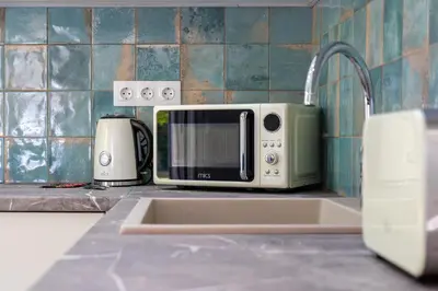 a microwave sitting on a kitchen counter next to a sink at Peaceful Private Bungalow VIPGreece in Athens
