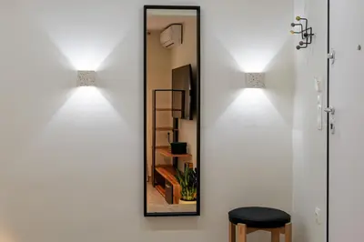 two lights on a wall next to a mirror at Peaceful Private Bungalow VIPGreece in Athens