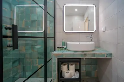 a bathroom with a sink and a glass shower at Peaceful Private Bungalow VIPGreece in Athens