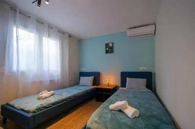 a bedroom with two beds and a window at Peaceful Private Bungalow VIPGreece in Athens