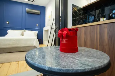 a red bag sitting on a table in a room at Stoa House Airport in Koropíon