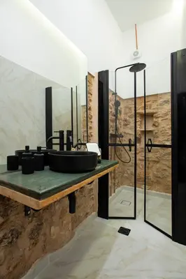 a bathroom with a sink and a shower at Stoa House Airport in Koropíon