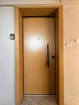 a wooden door in the middle of a room at Seashore Happiness Apartments in Porto Rafti