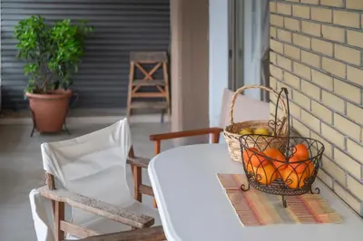 a basket of fruit on a table on a porch at Family Apt in Glyfada-Kyprou, by Comfortbnb in Athens
