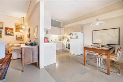 a kitchen with a table and a refrigerator at Family Apt in Glyfada-Kyprou, by Comfortbnb in Athens