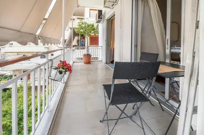 a balcony with two chairs and a table at Family Apt in Glyfada-Kyprou, by Comfortbnb in Athens