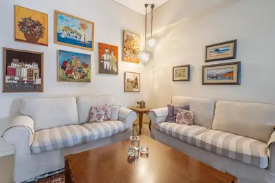a living room with two couches and a table at Family Apt in Glyfada-Kyprou, by Comfortbnb in Athens