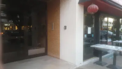 an entrance to a restaurant with a table and a glass door at Family Apt in Glyfada-Kyprou, by Comfortbnb in Athens