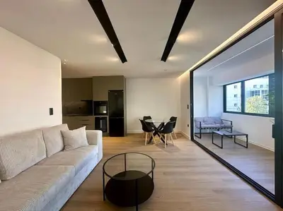 a living room with a couch and a table at BlueMotion - PortHub Α1 in Piraeus