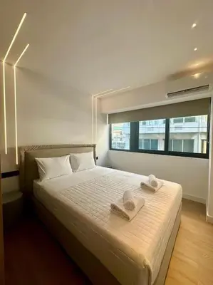 a bedroom with a bed with two towels on it at BlueMotion - PortHub Α1 in Piraeus