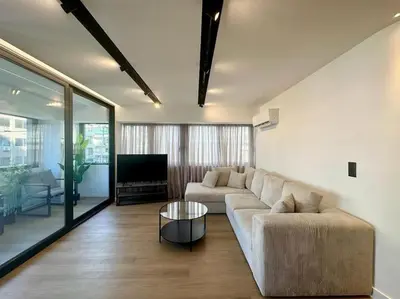 a living room with a couch and a television at BlueMotion - PortHub Α1 in Piraeus