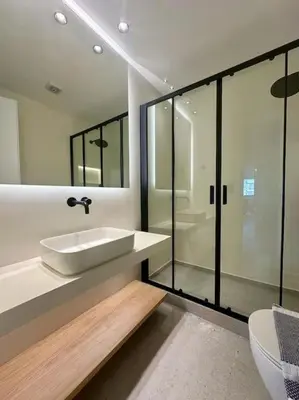 a bathroom with a sink and a glass shower at BlueMotion - PortHub Α1 in Piraeus