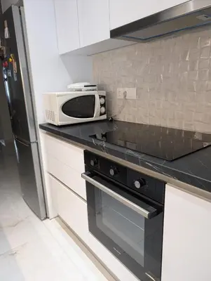a kitchen with a microwave sitting on a counter at Luxury & Spacious Apartment in Athens in Athens