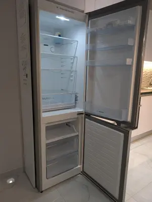 an empty refrigerator with its door open in a kitchen at Luxury & Spacious Apartment in Athens in Athens