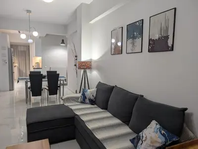 a living room with a couch and a dining room at Luxury & Spacious Apartment in Athens in Athens