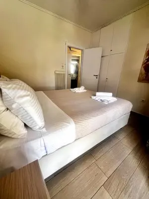 a bedroom with a large bed with white pillows at House Of Joy in Athens