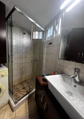 a bathroom with a shower and a sink at House Of Joy in Athens