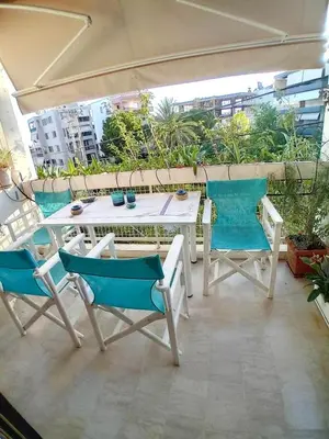 a white table and chairs on a balcony with a view at House Of Joy in Athens