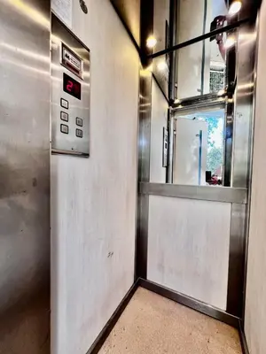 a metal elevator with a door and a window at House Of Joy in Athens