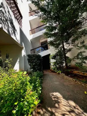 a building with a tree on the side of a road at House Of Joy in Athens