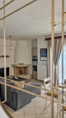 a living room with a couch and a table at H&H cozy retreat ,Fireplace and Parking in Piraeus