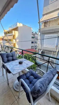 a table and chairs sitting on a balcony at H&H cozy retreat ,Fireplace and Parking in Piraeus
