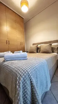 two beds sitting next to each other in a room at H&H cozy retreat ,Fireplace and Parking in Piraeus