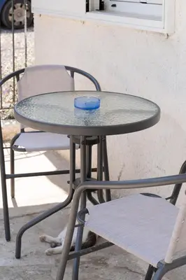 a table and chairs with a blue bowl on it at Panos Marina Apartment P1 in Porto Rafti
