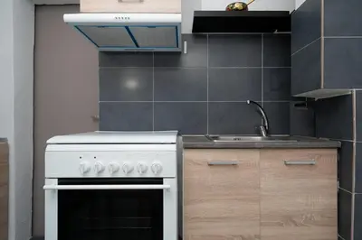 a kitchen with a white stove and a sink at Panos Marina Apartment P1 in Porto Rafti