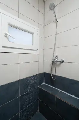 a bathroom with a shower with a shower head at Panos Marina Apartment P1 in Porto Rafti