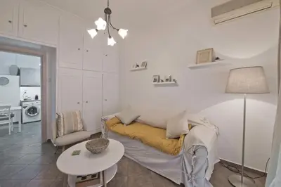 a living room with a couch and a table at Irida Stylish, Cozy, Fully Equipped Apt in Piraeus