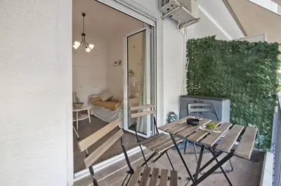 a patio with a table and chairs on a balcony at Irida Stylish, Cozy, Fully Equipped Apt in Piraeus