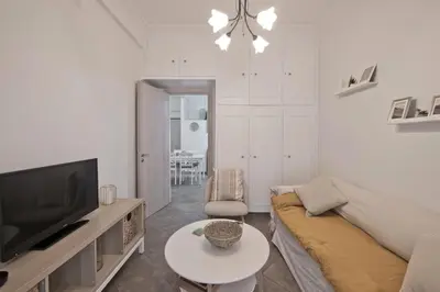 a living room with a couch and a tv and a table at Irida Stylish, Cozy, Fully Equipped Apt in Piraeus