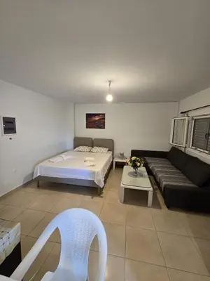 a living room with a bed and a couch at Monda Apartment in Piraeus