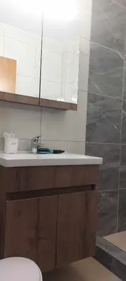 a bathroom with a sink and a toilet in it at Monda Apartment in Piraeus