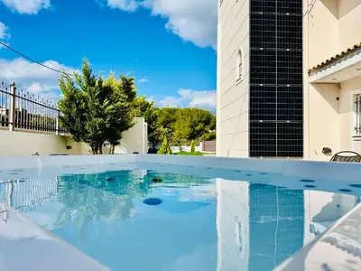 a swimming pool in front of a building at Airfenos - Athens Riviera in Anavissos