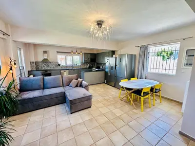a living room with a couch and a table at Airfenos - Athens Riviera in Anavissos