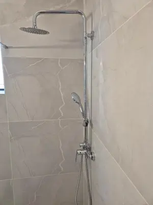 a shower with a shower head in a bathroom at Feel Breeze Athens in Athens