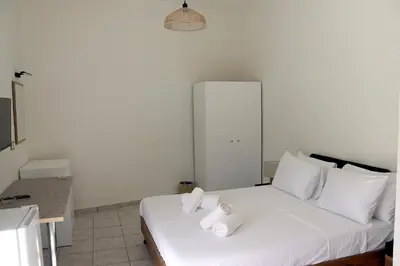 a bedroom with a white bed with towels on it at Feel Breeze Athens in Athens