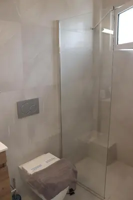a bathroom with a glass shower with a toilet at Feel Breeze Athens in Athens