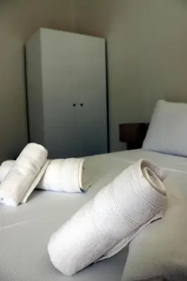 a pair of wrapped up towels on a bed at Feel Breeze Athens in Athens