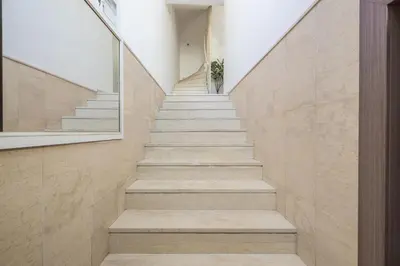 a staircase in a house with stone walls at Seaside Corner Kastella Getaway in Piraeus